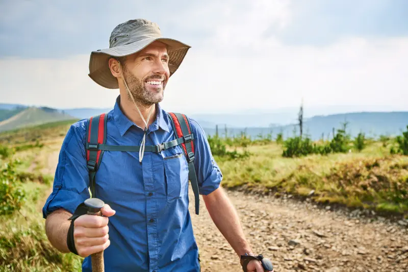 portrait-of-smiling-man-hiking-in-the-mountains-2024-09-22-08-31-49-utc.webp
